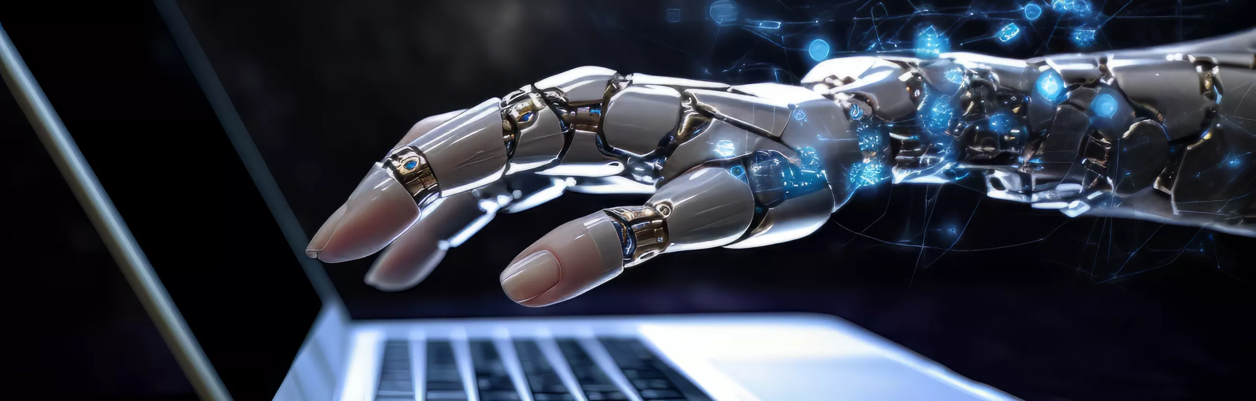 ręka robota nad klawiaturą laptopa